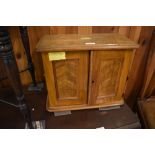 A Victorian figured walnut table cabinet, the panelled doors opening to reveal the now vacant