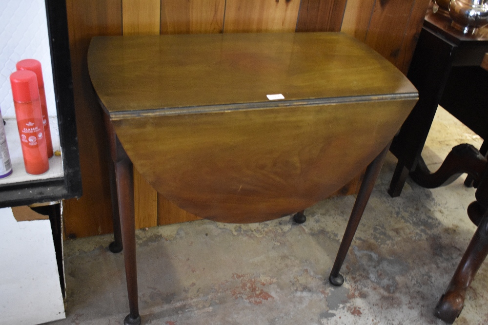 1920s mahogany Pembroke type table, having demilune flaps, turned supports and bun feet. 72cm.