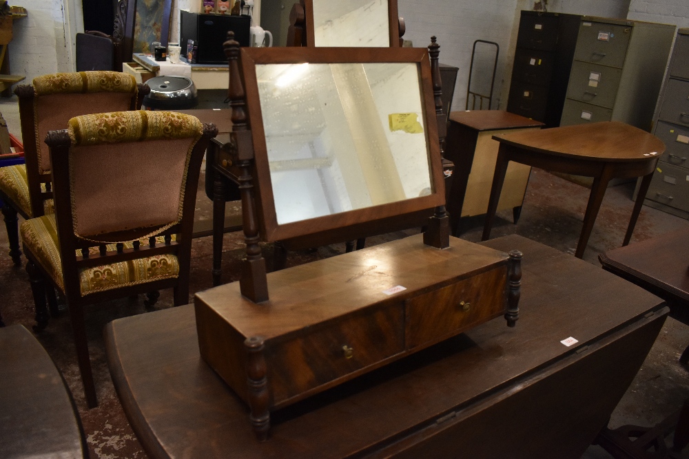 A 19th century figured mahogany swing toilet mirror, with turned upright and supports. The