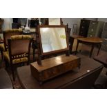 A 19th century figured mahogany swing toilet mirror, with turned upright and supports. The