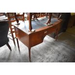 A Reproduction mahogany bow fronted writing desk with single central drawer flanked by cupboards,