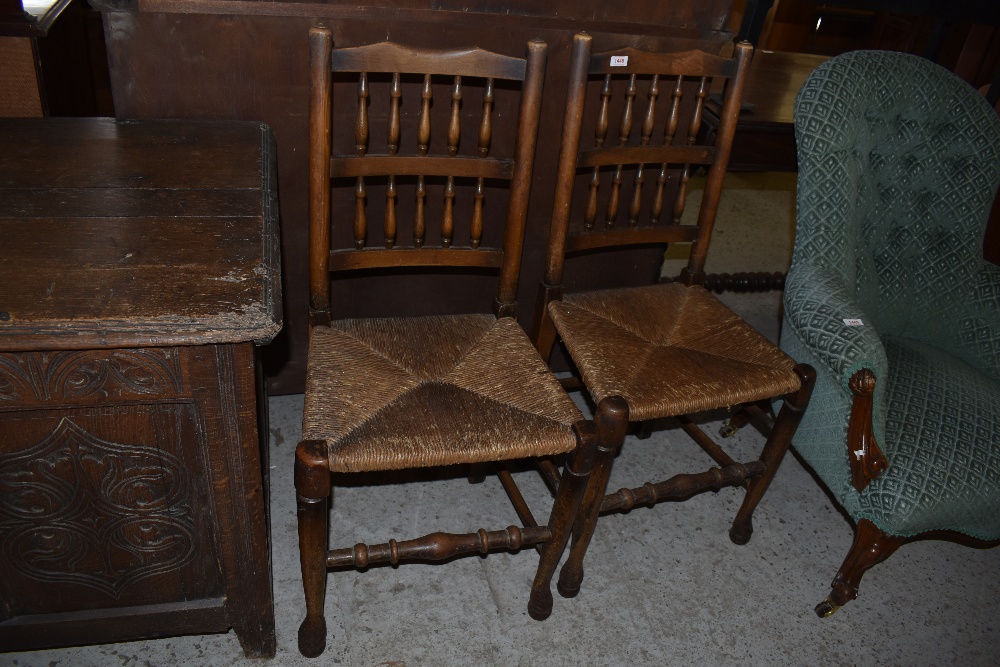 A pair of 19th century rush seated spindle back chairs. Seat height. 46CM.