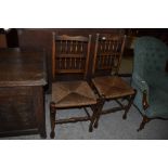 A pair of 19th century rush seated spindle back chairs. Seat height. 46CM.