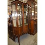 An Edwardian banded mahogany display cabinet, having a slender moulded cornice and geometric