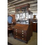 A George III astragal glazed oak bureau bookcase, of traditional design, the glazed top appears to