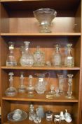 A quantity of mixed glasswares, comprising decanters, biscuit barrel, jug, vase, candlestick,