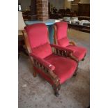 A pair of Victorian mahogany his and hers easy chairs, upholstered in deep red material, each with