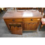 A Victorian mahogany two drawer and two door cupboard. (AF) 74CM.