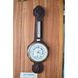 The 20th century aneroid barometer, having rudimentary carving and enameled dial. 76CM