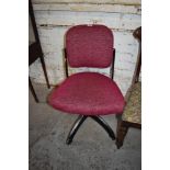 A mid century metal framed office or machinists chair, later upholstered in pink material, having