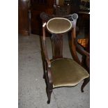 An Art Nouveau mahogany armchair, with foliate carved and pierced detail, pierced central splat over