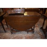 A 20th century reproduction oak gateleg table, having bobbin turned supports and beaded detail.