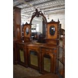 A Victorian inlaid mahogany mirror back sideboard the central arched and bevelled plate with foliate