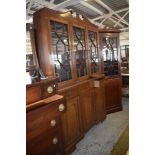 A 'Cresta' reproduction mahogany astragal glazed bookcase, with broken swan neck pediment over three