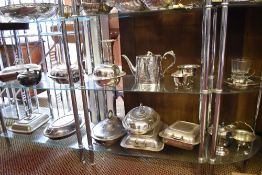 Two shelves of silver plated wares, to include mainly entree dishes.