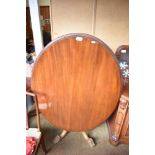 A Victorian mahogany oval loo table of traditional form, the base with turned and carved column
