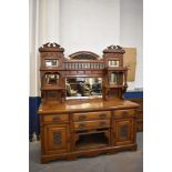 A large Victorian mirror back sideboard, the raised mirror back with central stipple carved arch