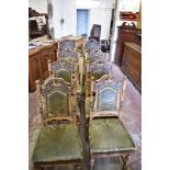 A set of eight Victorian carved oak leather upholstered dning chairs, having profusely stipple