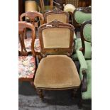 A pair of Victorian oak upholstered chairs, with carved and moulded decoration, the slightly bowed