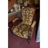 A Victorian walnut upholstered armchair, having a deep buttoned padded back and scrolled partially