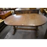 A 20th century oak extending dining table of rounded rectangular form with trestle style base 75 CM.