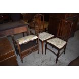 Two Edwardian inlaid mahogany bedroom chairs, each with boxwood stringing and conforming upholstery.