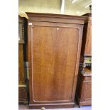 A continental mahogany armoire, the moulded panel door with re-entrant corners. 221CM X 122CM.