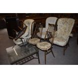 A group of three Ercol dark elm stick back lounge chairs, all together with a pair of Ercol dark elm