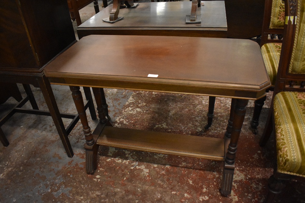 A Victorian mahogany side table. of canted rectangular form with turned support, linked by a plain