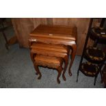 A nest of three modern imported wood tables of 19th century design. Largest. 65CM.