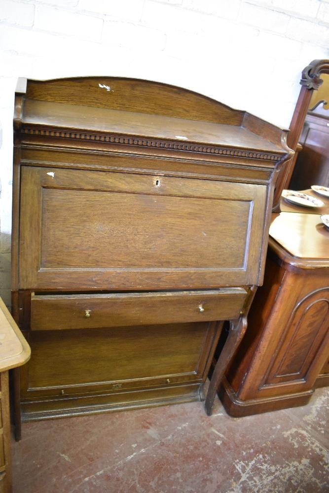 An early 20th century oak 'The Lebus Bookcase' bureau, the upper stage of traditional design over