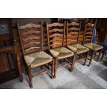 A set of four good quality reproduction oak rush seated ladderback chairs, Seat height. 48CM.