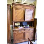 A Victorian pitch pine aesthetic period two stage sideboard, having spindled surmount over moulded