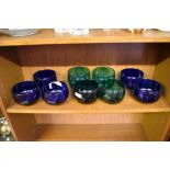 A group of nine coloured glass finger bowls, comprising five Bristol blue and four green glass.
