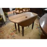 An unusual 19th century oak extending dropleaf dining table, extending from the centre line and