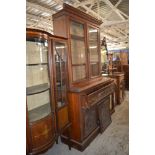 An Edwardian mahogany bookcase, the upper stage with moulded cornice above plain glazed doors, the