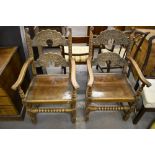 A pair of reproduction oak Derbyshire style armchairs, with typical domed rails, solid seats,
