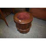 A Victorian mahogany commode, having a hinged and moulded circular top over a fluted cylindrical