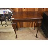 A 20th century figured mahogany card table, with folding top and swivel action. Small depletion to