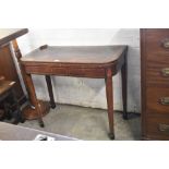 A George III banded mahogany fold over card table, having inlaid frieze and tapering square