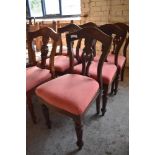 A set of six Victorian mahogany dining chairs with arched backs and carved and pierced central