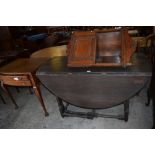 A 20th century reproduction drop leaf gateleg table sold together with a mahogany bureau,