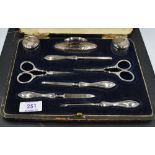 A cased George V silver mounted manicure set, complete, the silver mounts with marks for