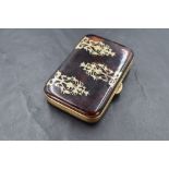 A late 19th century gilt metal and tortoiseshell purse, of hinged rectangular form with inset ornate