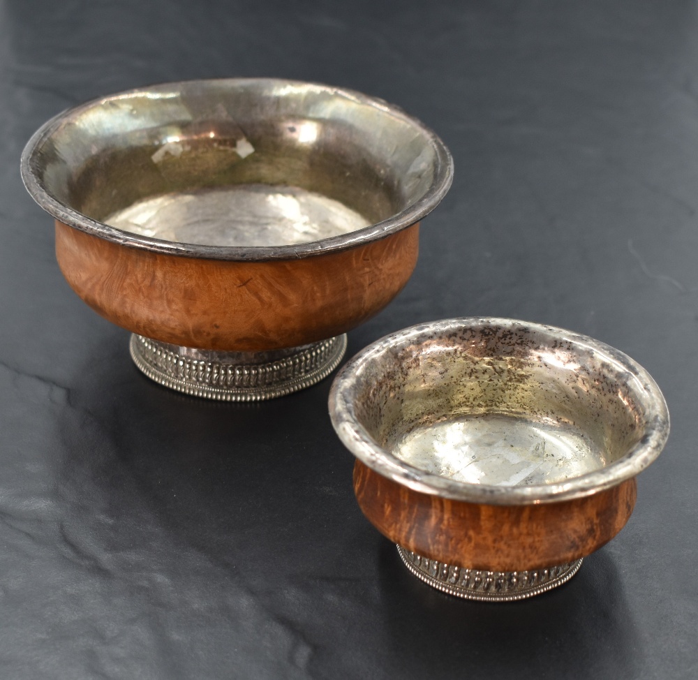 A 19th century Chinese white metal mounted burr wood mazer bowl, of turned form with white metal