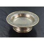 A Chinese white metal dish, of circular form with rolled rim and nicely engraved border enclosing