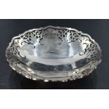An Elizabeth II silver dish, of circular form with shaped outline and hand-pierced repeating foliate