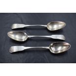 Three Queen Anne silver dessert spoons of fiddle back pattern having monogram to terminals and