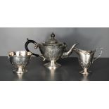 A George V silver bachelors three piece teaset, of tapering cylindrical form with strap-work