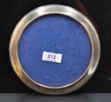A modern silver mounted circular photograph frame, with beaded inner edge detail, wall mounting